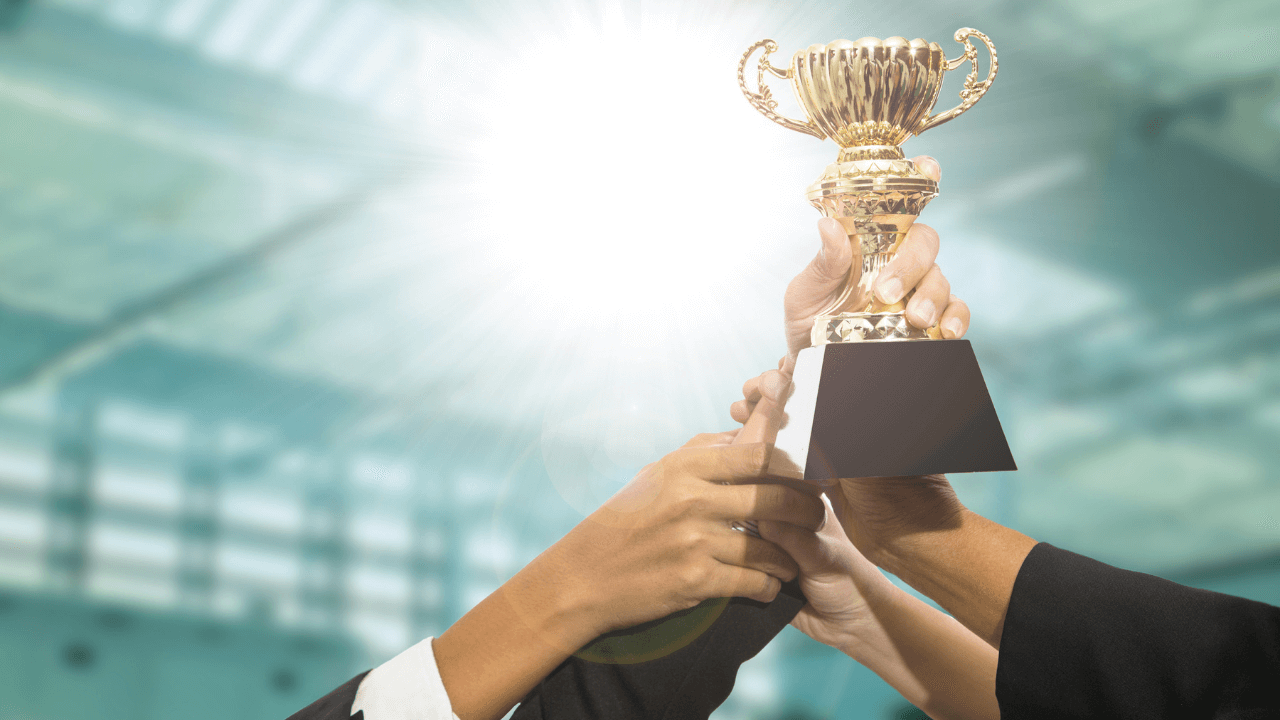 Hands holding up an award | Scott Legal, P.C. Hands holding up an award