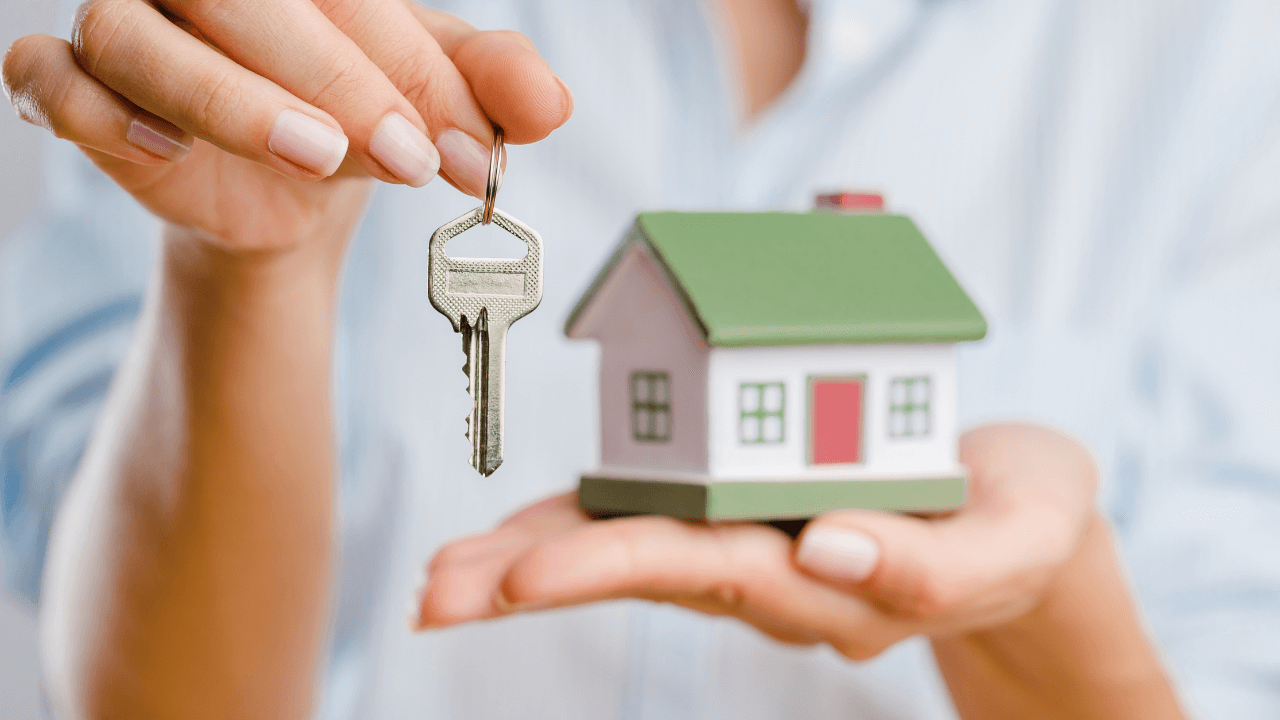 Woman holding a key and house in her hands | Scott Legal, P.C. Woman holding a key and house in her hands