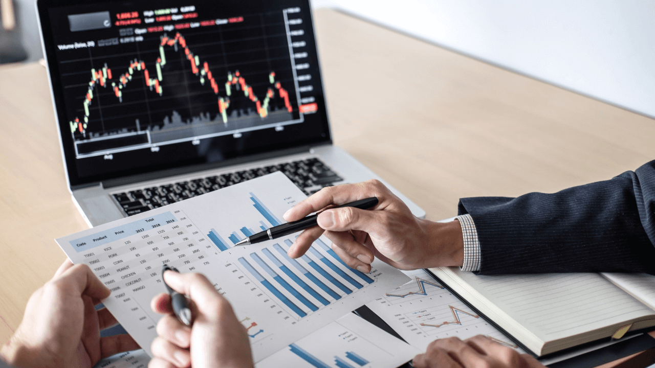 Investors looking at charts | Scott Legal, P.C. Investors looking at charts