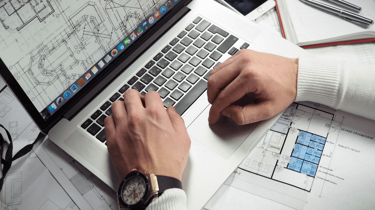 entrepreneur going over plans on laptop | Scott Legal, P.C. entrepreneur going over plans on laptop