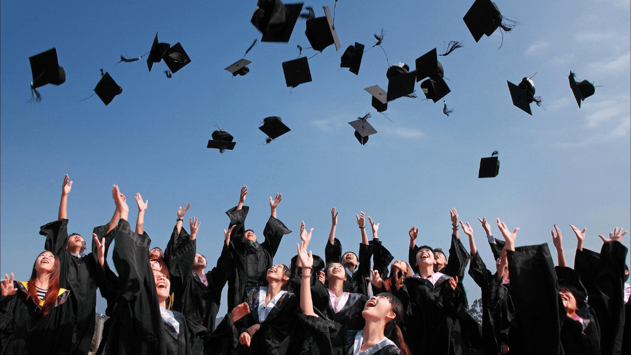 Students throwing their caps at graduation | Scott Legal, P.C. Students throwing their caps at graduation