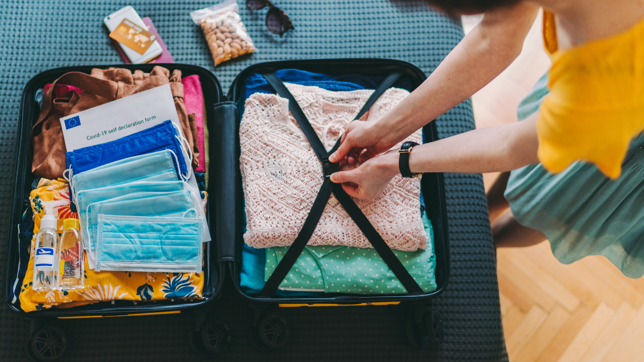 woman packing travel luggage covid masks included | Scott Legal, P.C. woman packing travel luggage covid masks included