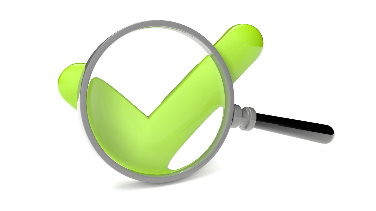 A green check mark and magnifying glass | Scott Legal, P.C. A green check mark and magnifying glass