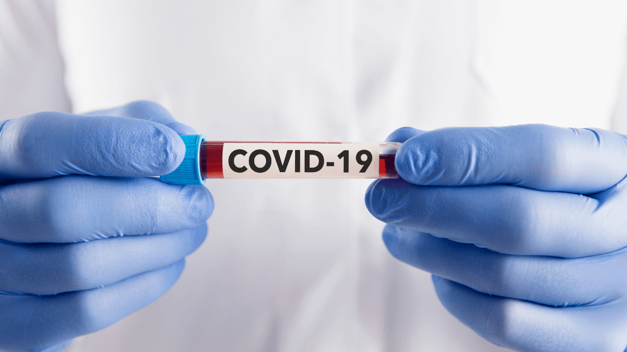 Doctor holding covid 19 vial | Scott Legal, P.C. Doctor holding covid 19 vial
