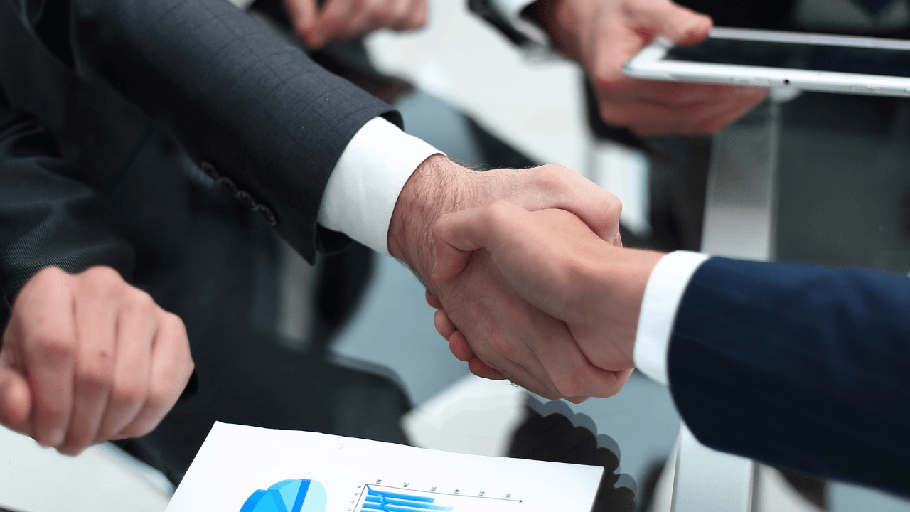 investors and employees shaking hands in an office | Scott Legal, P.C. investors and employees shaking hands in an office