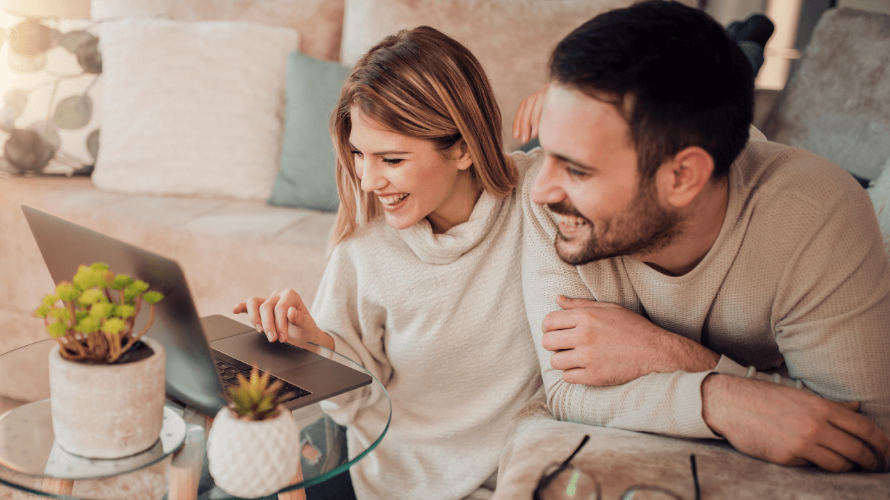 Two happy people excited at seeing their immigration approval on their laptop | Scott Legal, P.C. Two happy people excited at seeing their immigration approval on their laptop