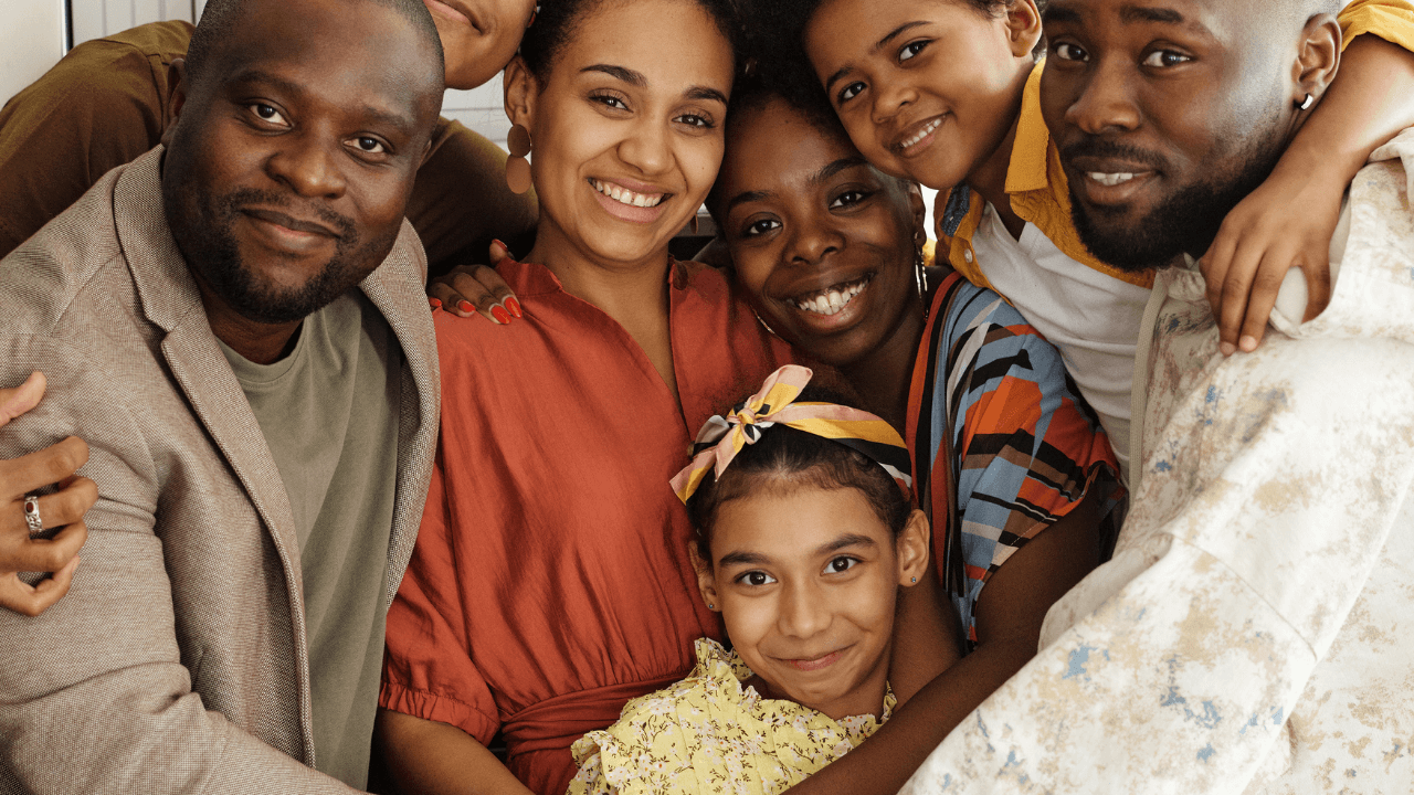 A family of 7 embracing each other while smiling | Scott Legal, P.C. A family of 7 embracing each other while smiling