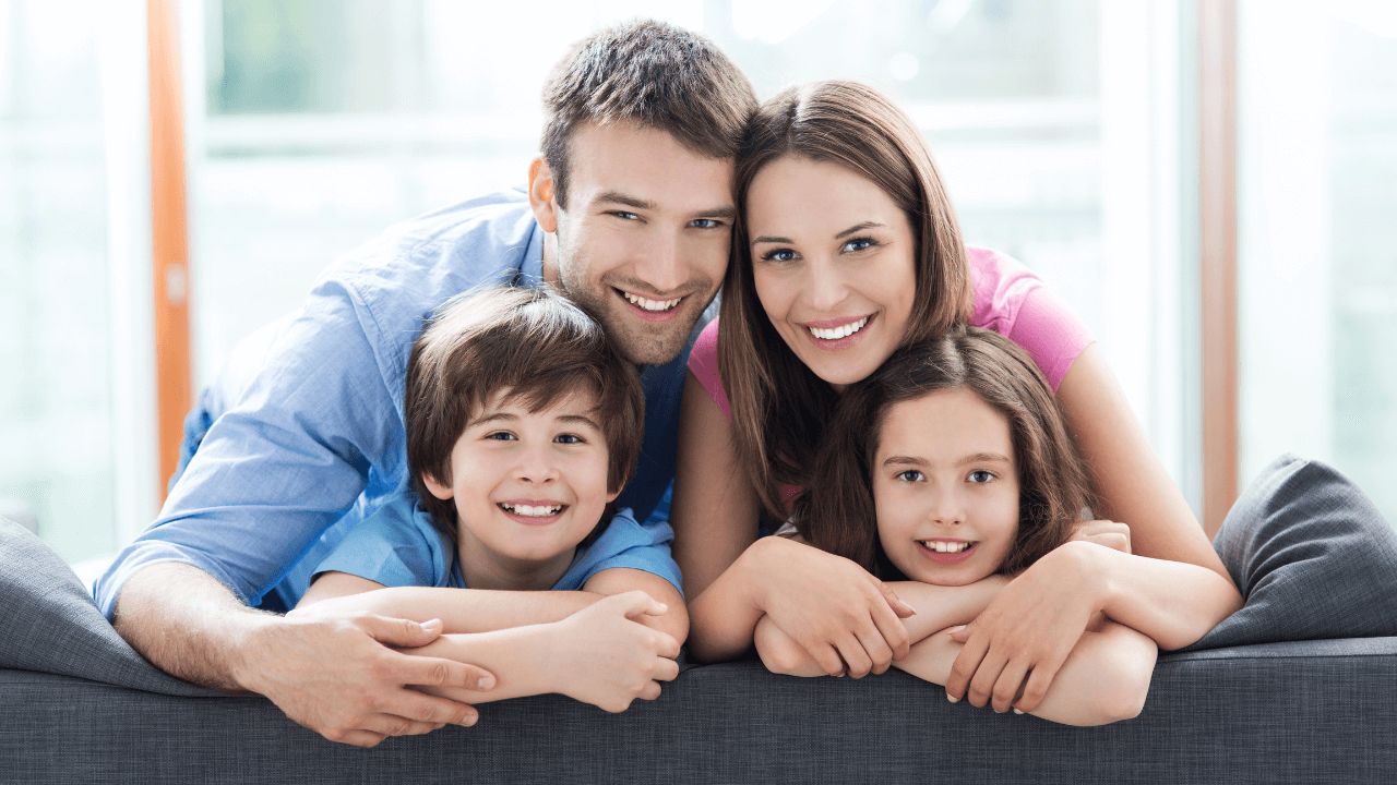 A family- mother, father, and two children smiling | Scott Legal, P.C. A family- mother, father, and two children smiling