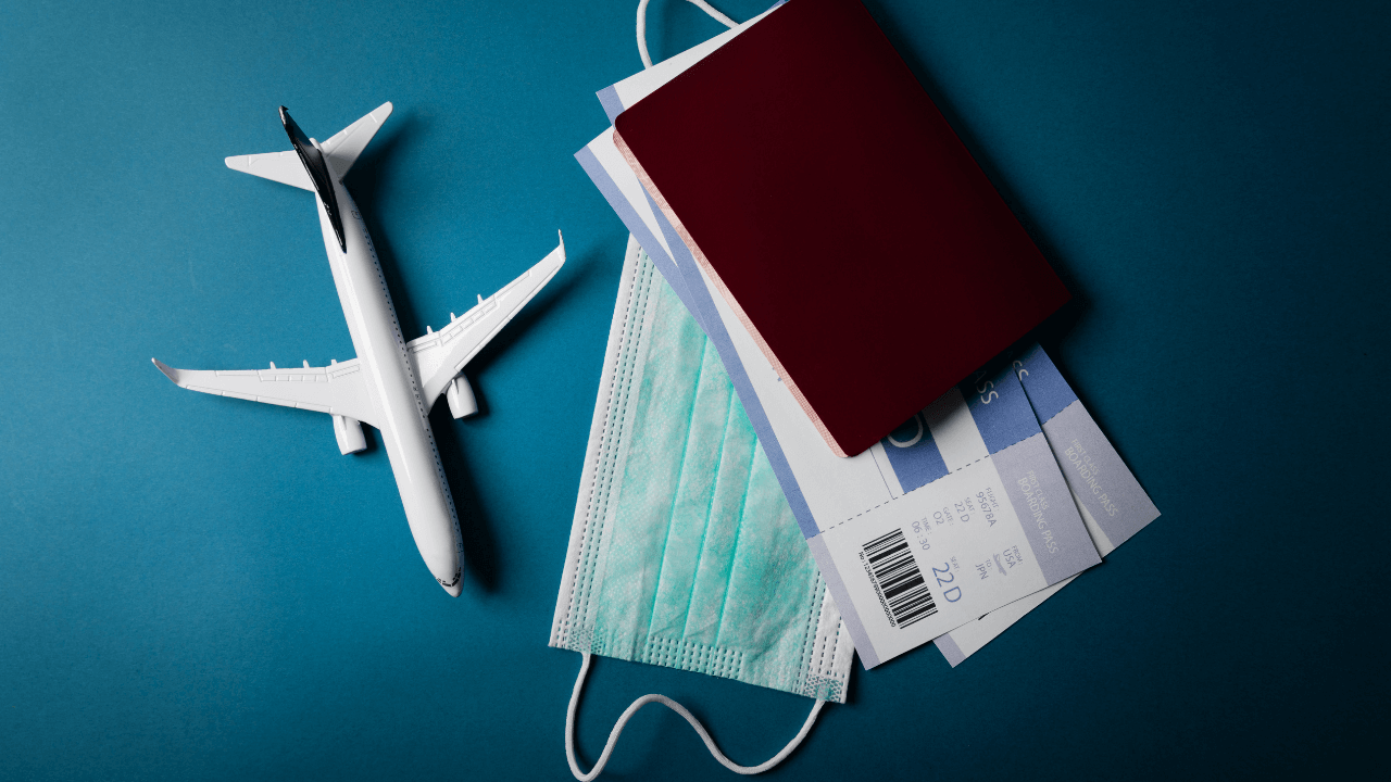 an airplane, passport, mask, and airline tickets | Scott Legal, P.C. an airplane, passport, mask, and airline tickets