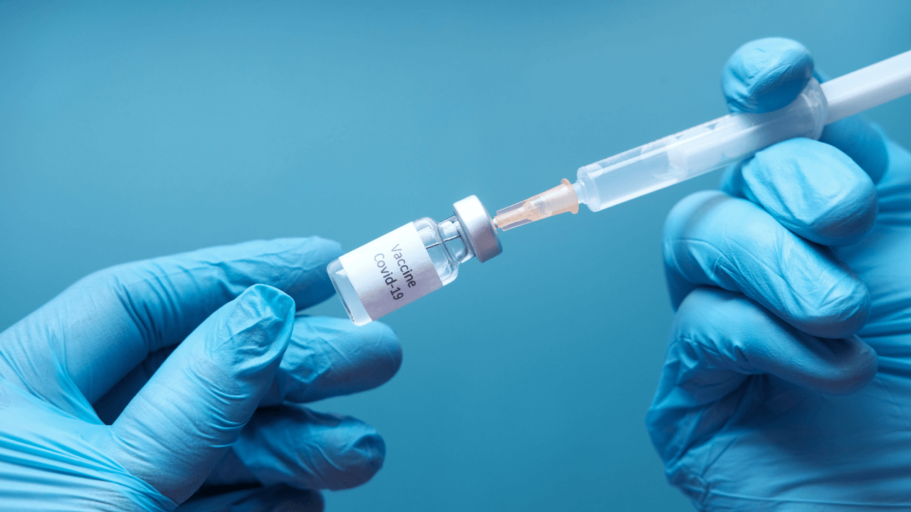 doctor holding covid vaccine | Scott Legal, P.C. doctor holding covid vaccine