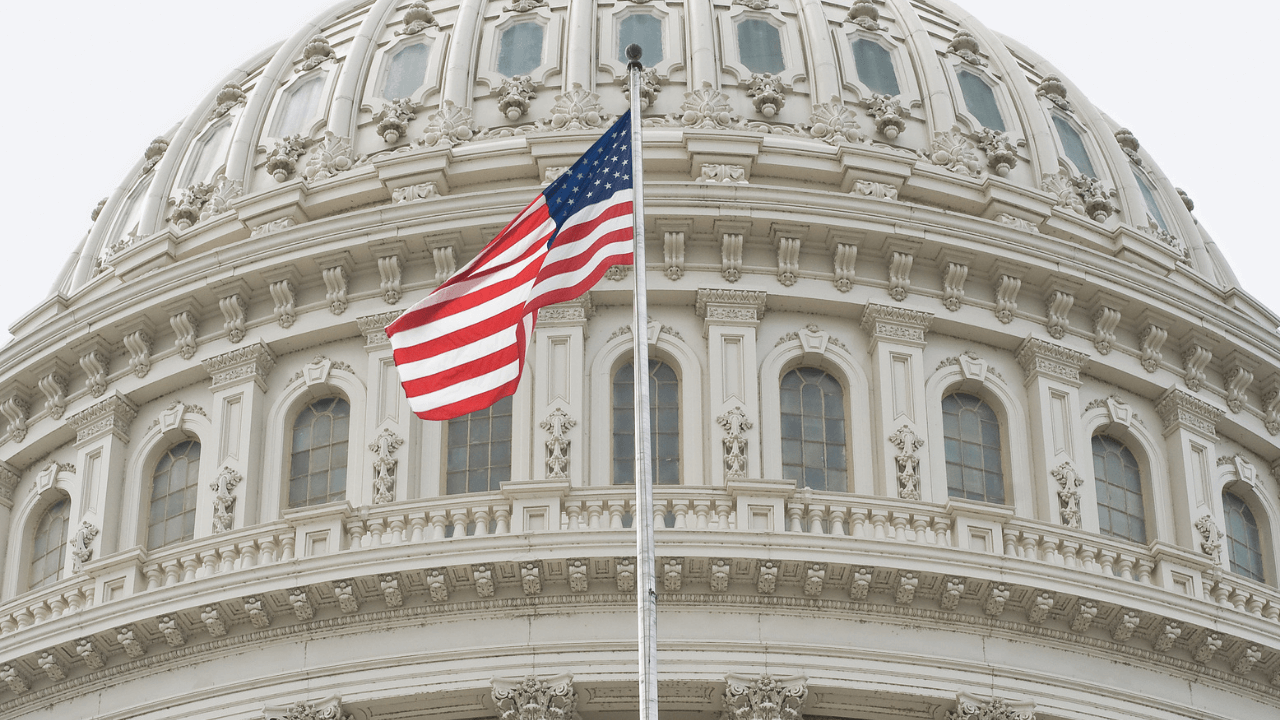 A US flag post in front of a parliament building | Scott Legal, P.C. A US flag post in front of a parliament building