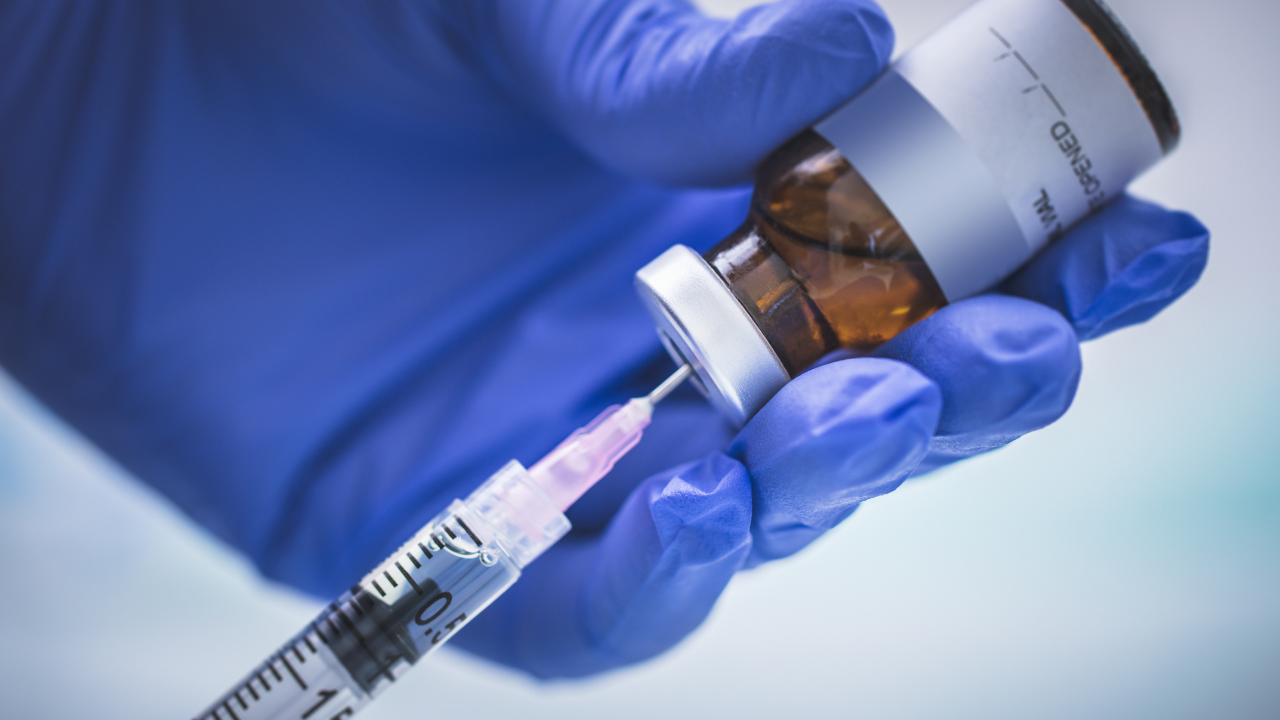 a doctor administering a vaccine | Scott Legal, P.C. a doctor administering a vaccine