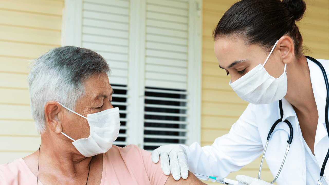 a doctor administering a vaccine | Scott Legal, P.C. a doctor administering a vaccine
