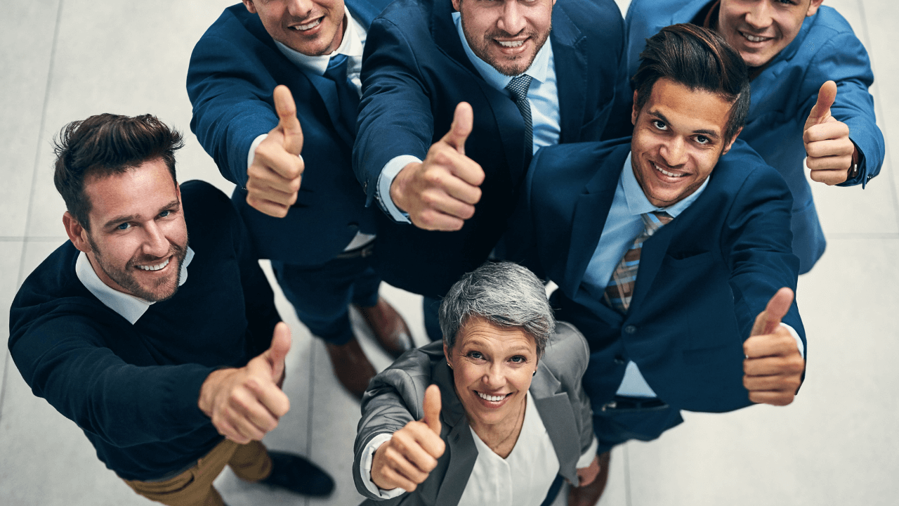 An office team giving thumbs up after another approval | Scott Legal, P.C. An office team giving thumbs up after another approval