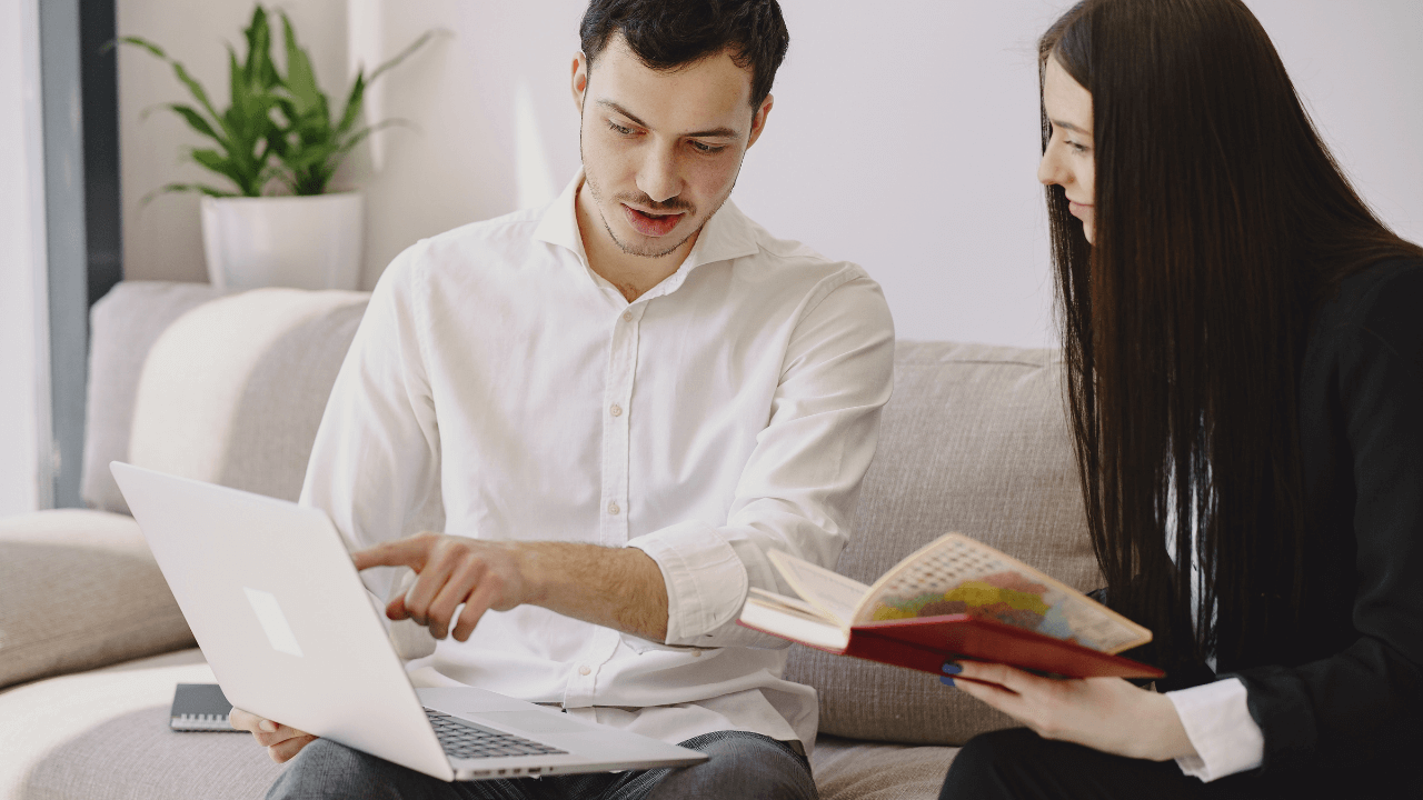A man and a woman working together on a laptop | Scott Legal, P.C. A man and a woman working together on a laptop
