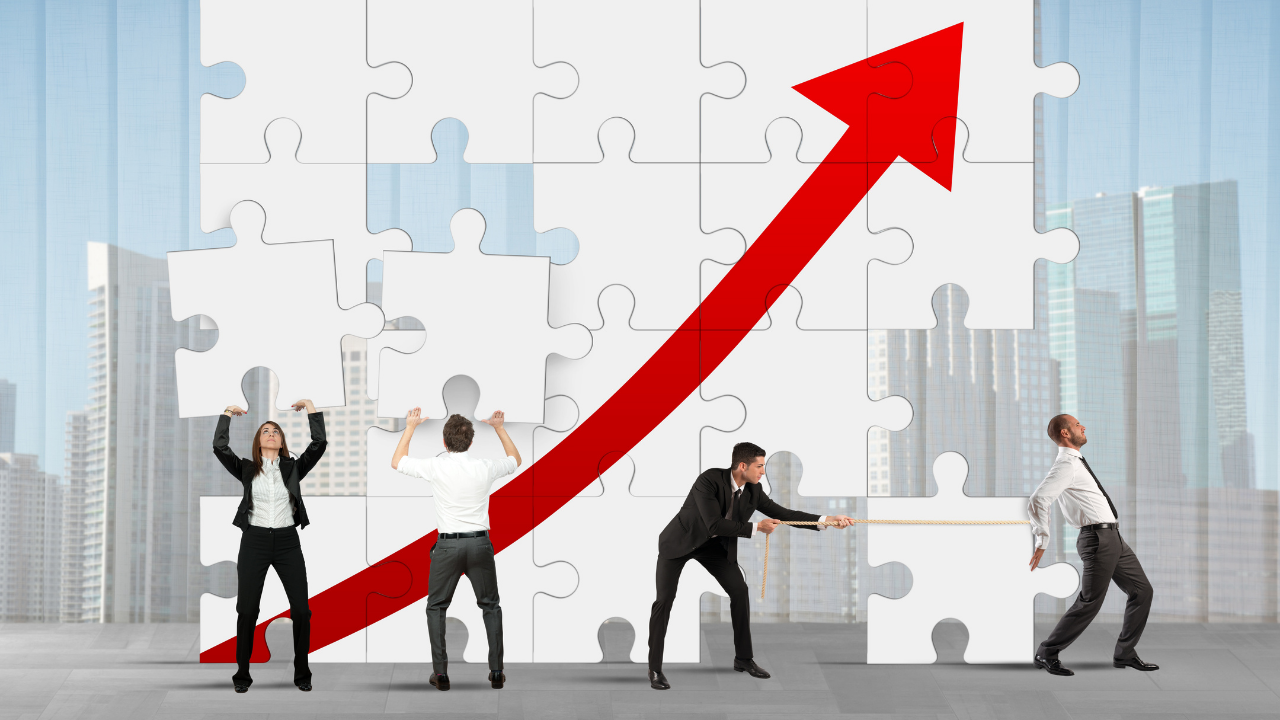 A business team of 4 fitting puzzle pieces together | Scott Legal, P.C. A business team of 4 fitting puzzle pieces together