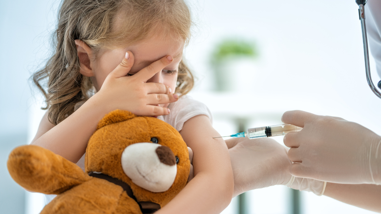 a kid and her teddy bear getting vaccinated | Scott Legal, P.C. a kid and her teddy bear getting vaccinated
