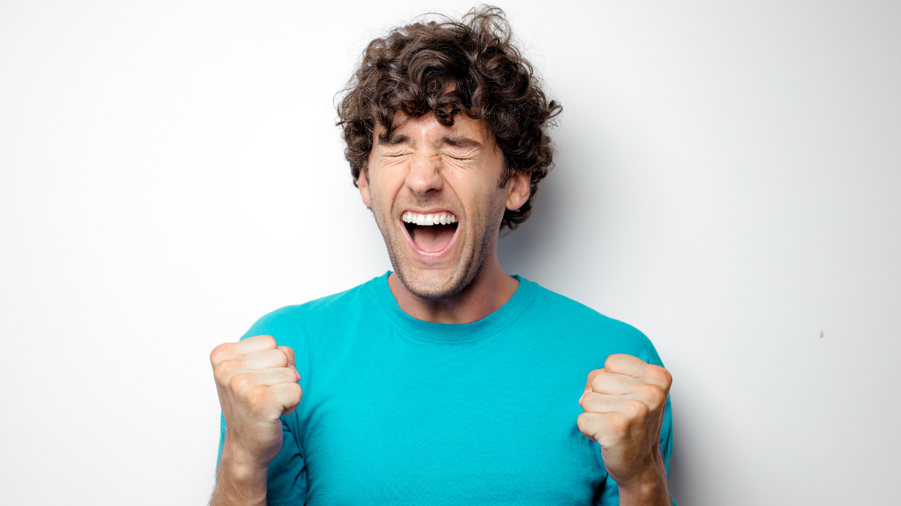 A man celebrating an exciting win | Scott Legal, P.C. A man celebrating an exciting win