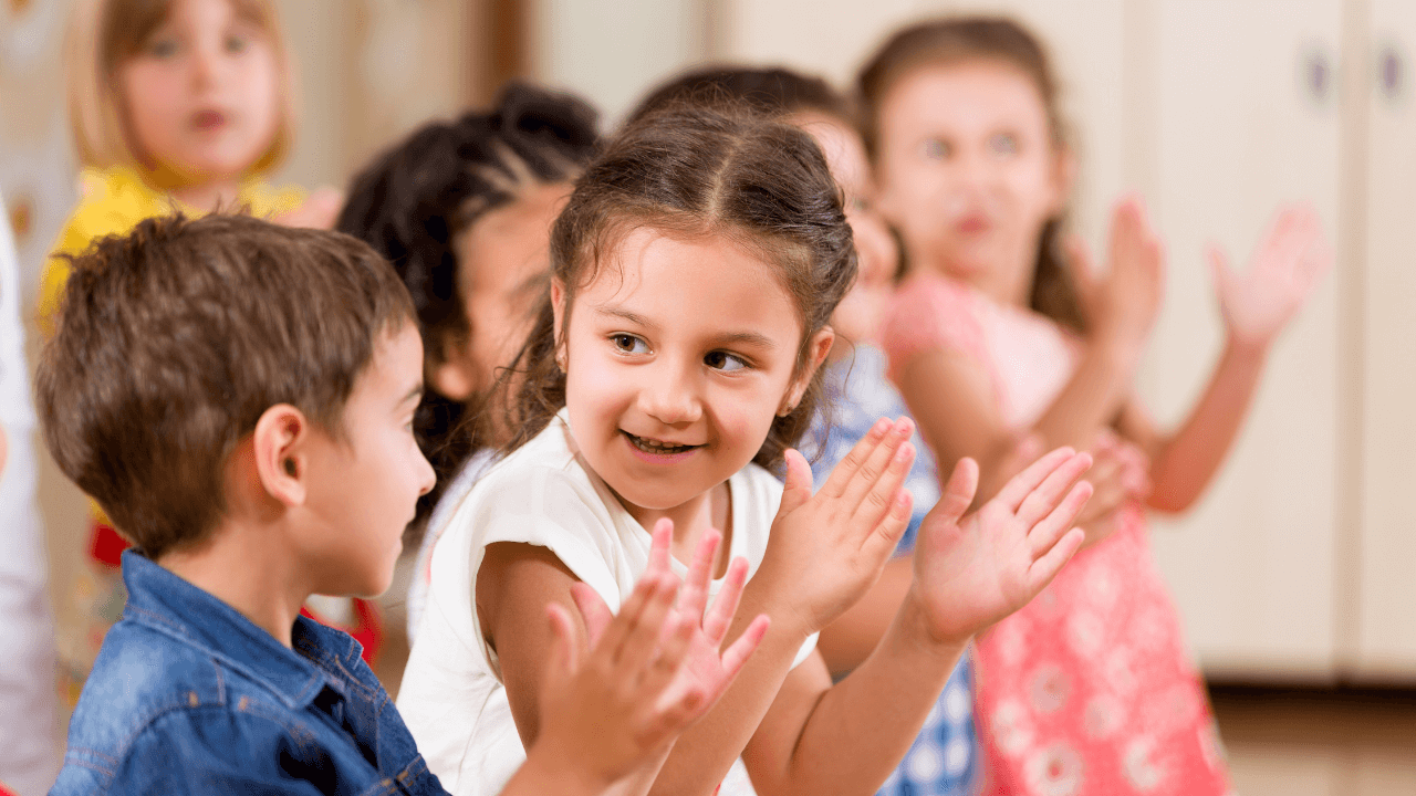 A bunch of children clapping together | Scott Legal, P.C. A bunch of children clapping together