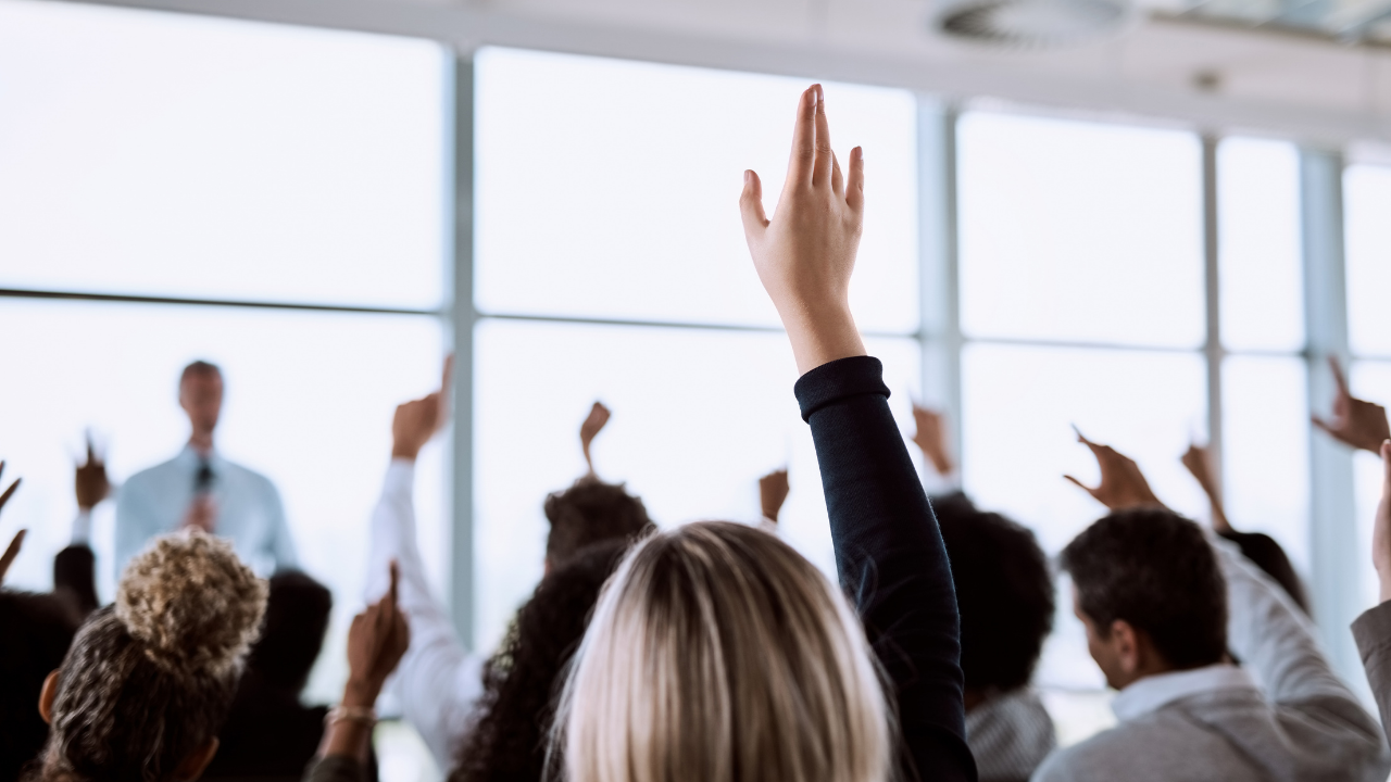 People raising their hands to ask a question | Scott Legal, P.C. People raising their hands to ask a question