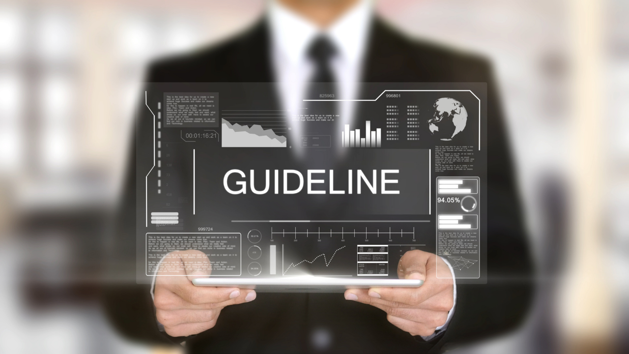 A man holding a tablet that projects the word "Guideline" in front of him | Scott Legal, P.C. A man holding a tablet that projects the word "Guideline" in front of him