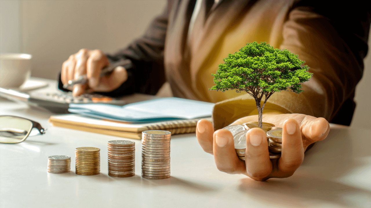 An investor holding a tree that grew from his investments | Scott Legal, P.C. An investor holding a tree that grew from his investments