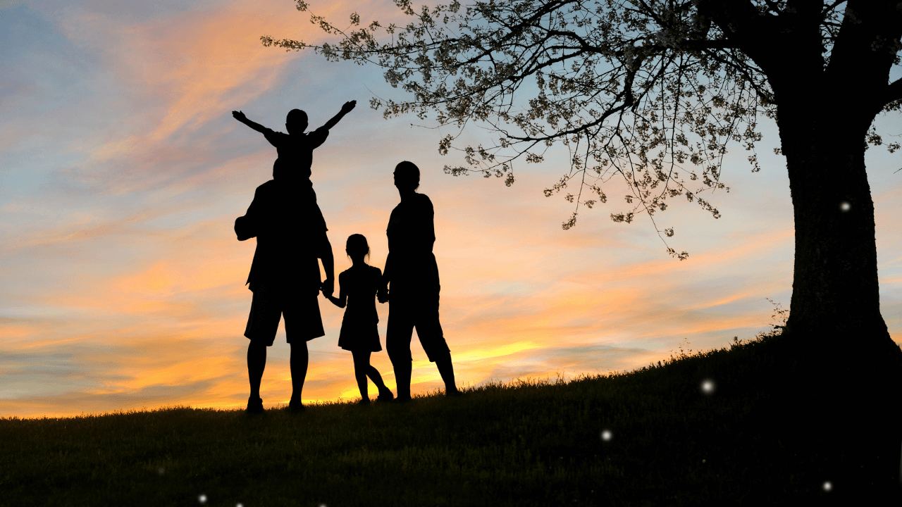 A family standing under a tree | Scott Legal, P.C. A family standing under a tree