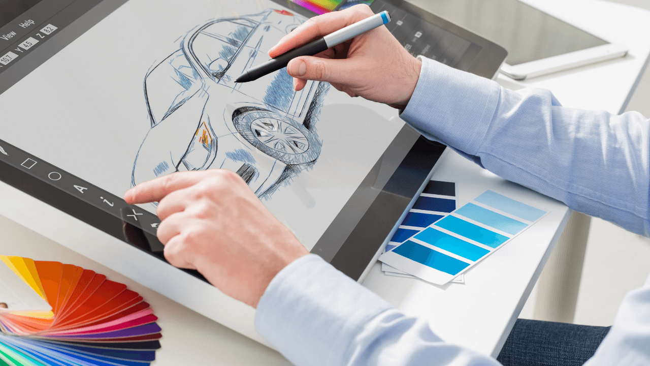 A graphic designer working on a car design on a tablet with color swatches next to them | Scott Legal, P.C. A graphic designer working on a car design on a tablet with color swatches next to them