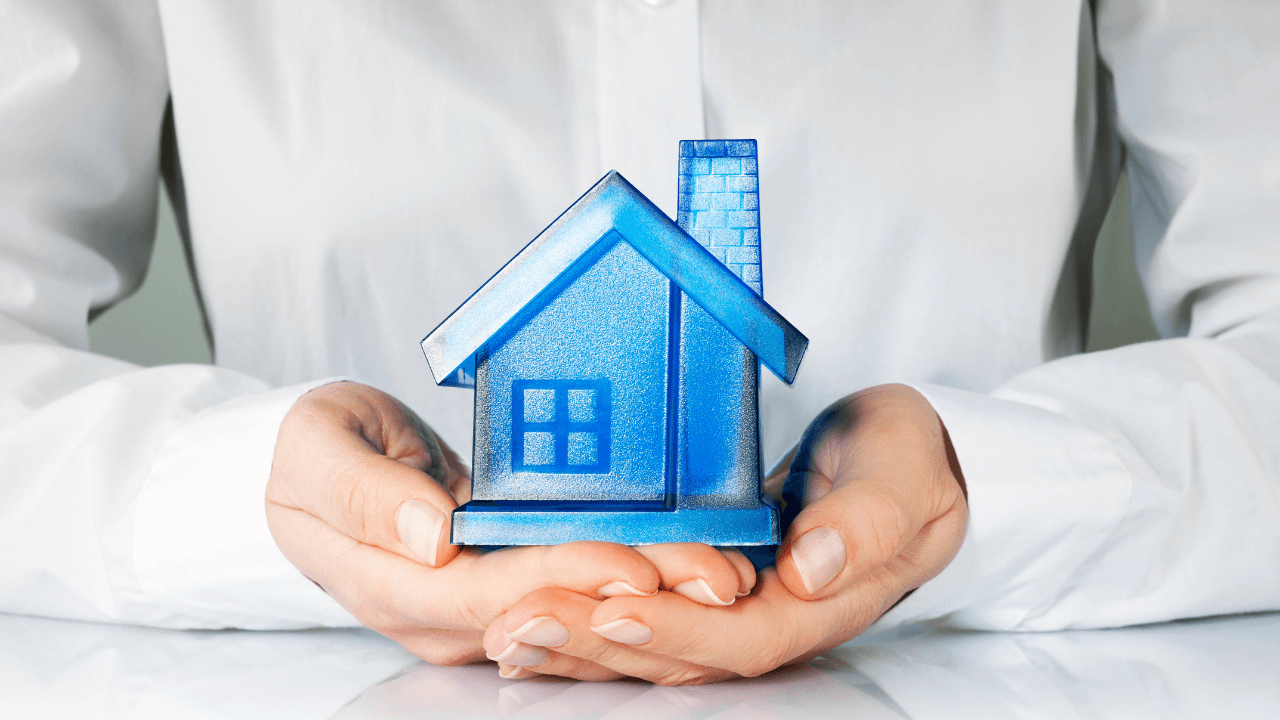 Hands holding a blue house | Scott Legal, P.C. Hands holding a blue house