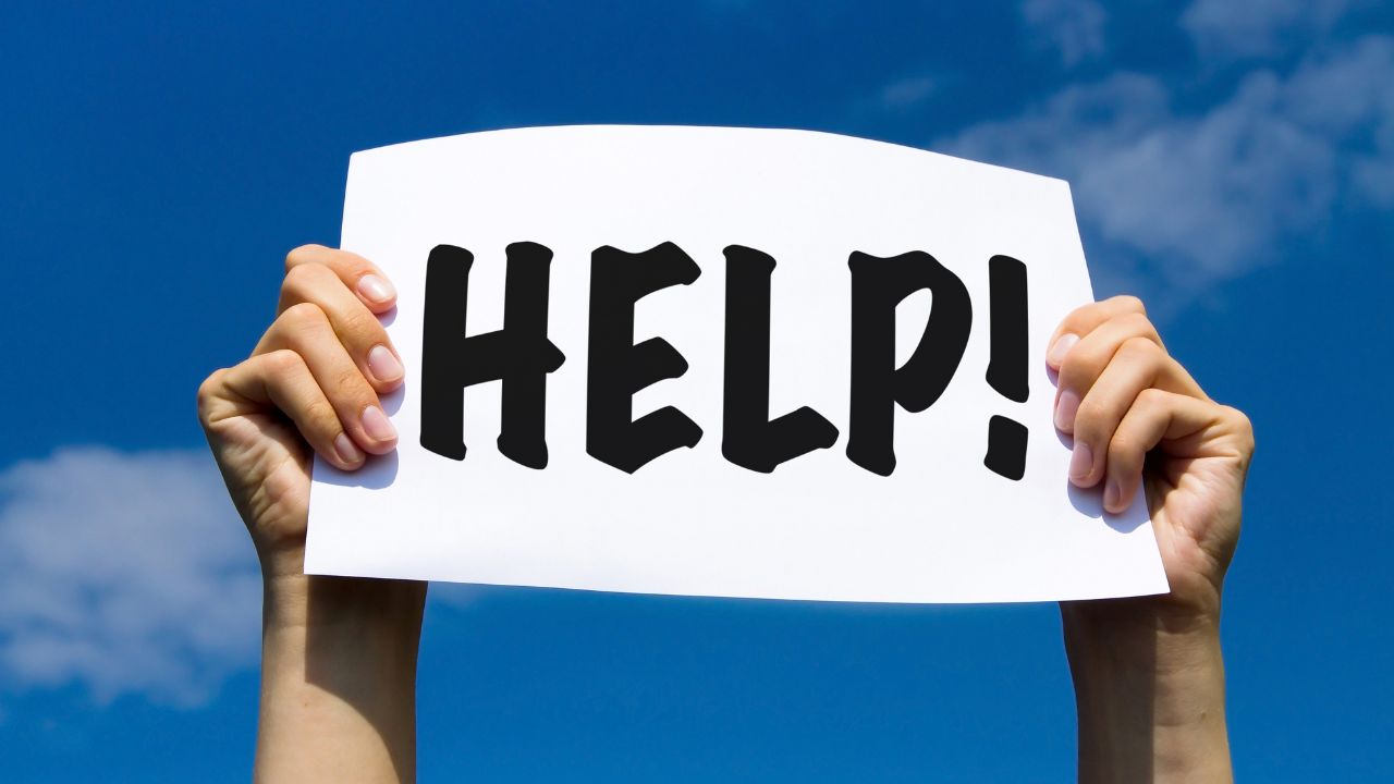 man holding a help sign | Scott Legal, P.C. man holding a help sign