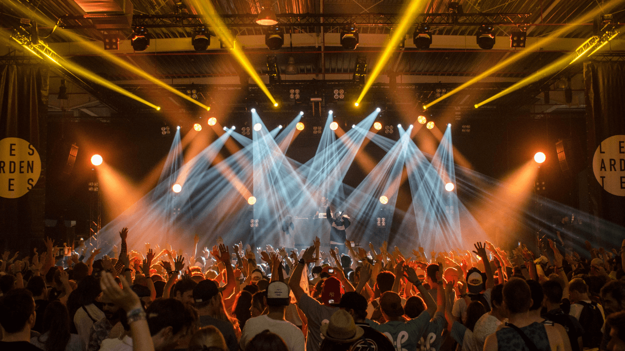 A concert venue with bright lights and a full crowd | Scott Legal, P.C. A concert venue with bright lights and a full crowd