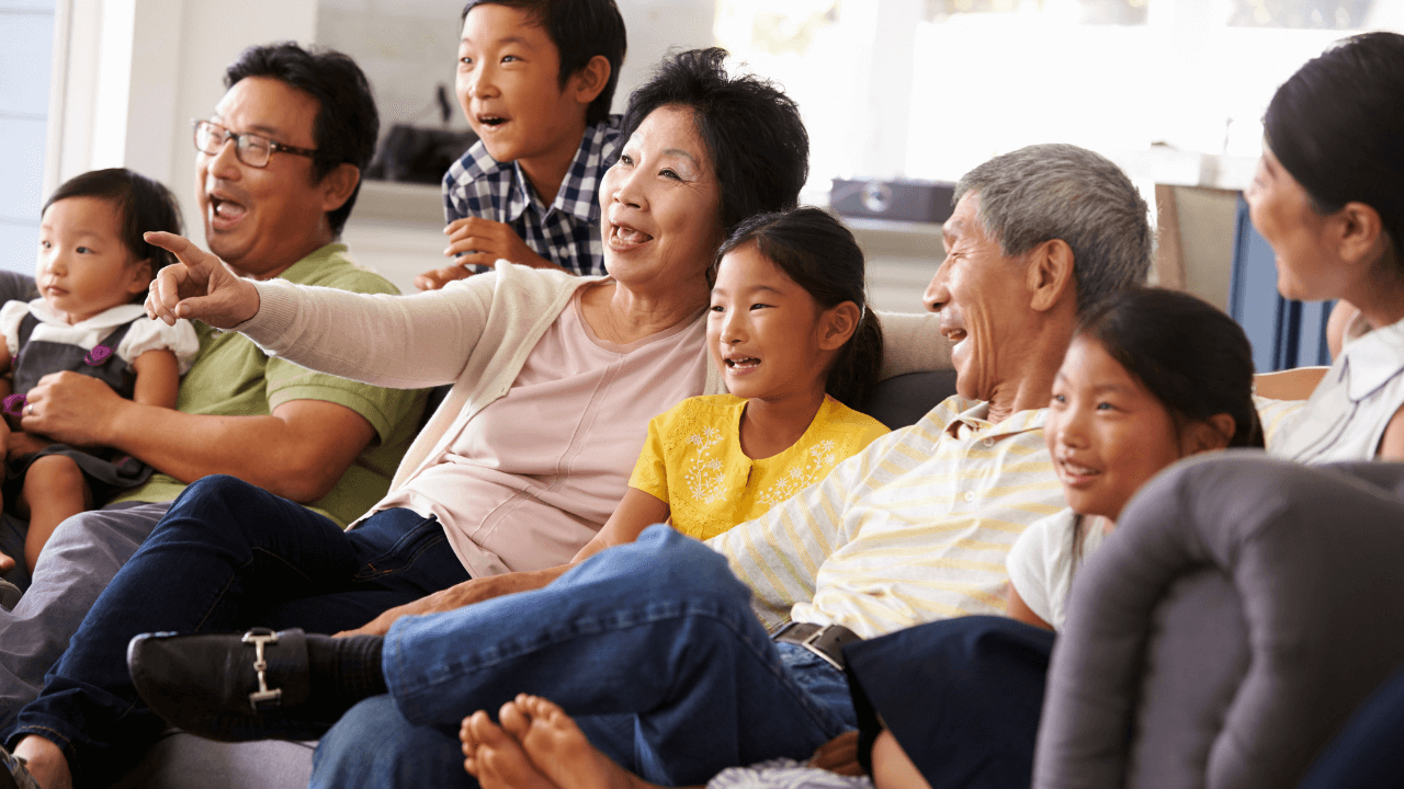 An extended family enjoying a family night together on a couch | Scott Legal, P.C. An extended family enjoying a family night together on a couch