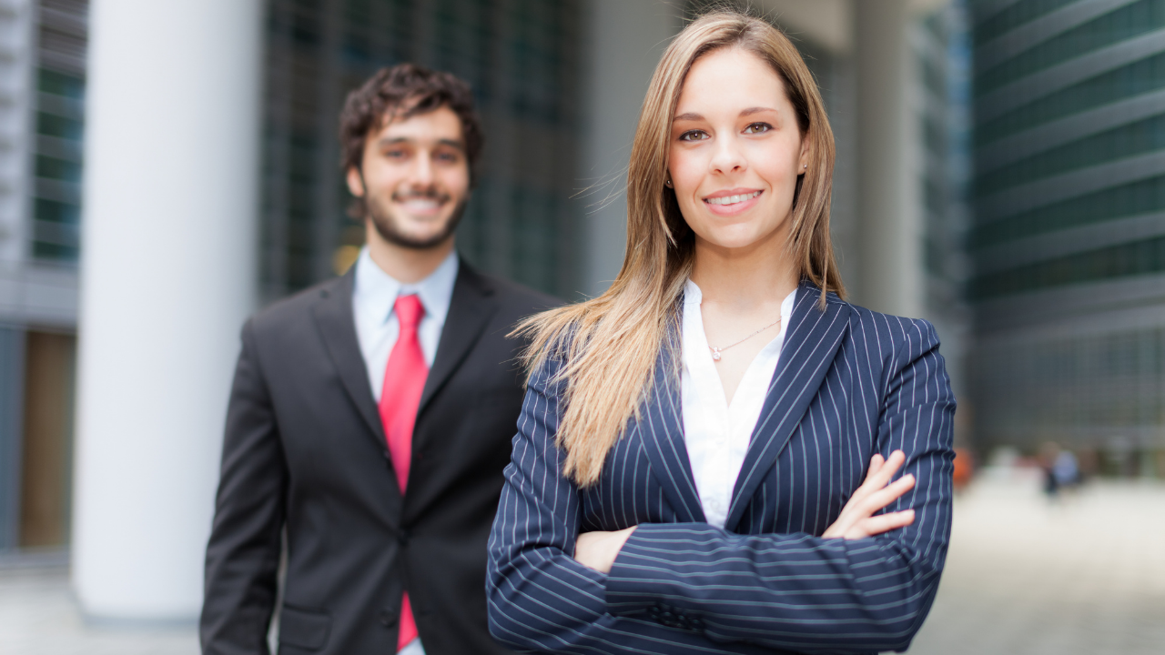 two partners in business attire standing outside their workplace | Scott Legal, P.C. two partners in business attire standing outside their workplace