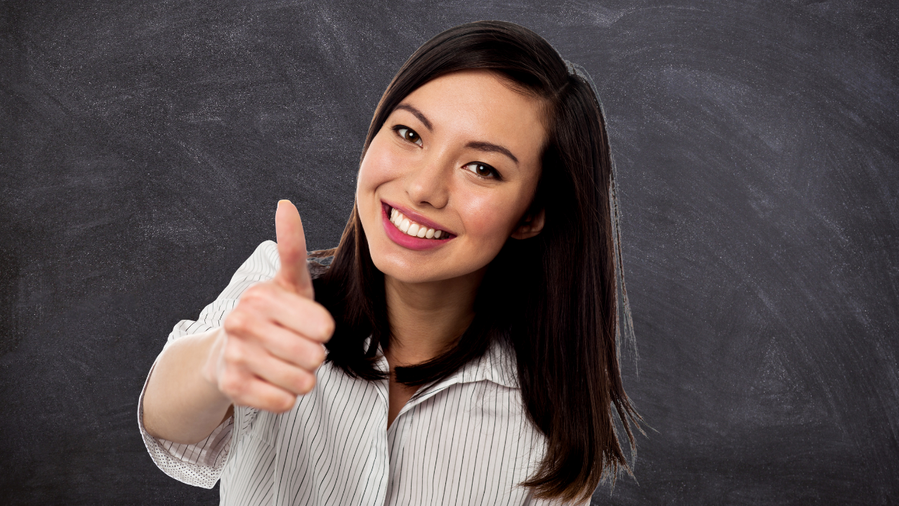 A woman smiling while indicating a thumbs up | Scott Legal, P.C. A woman smiling while indicating a thumbs up