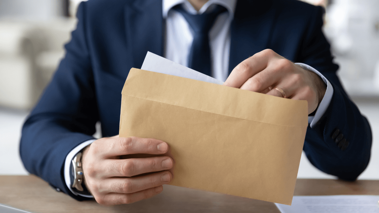 A man opening his mail | Scott Legal, P.C. A man opening his mail