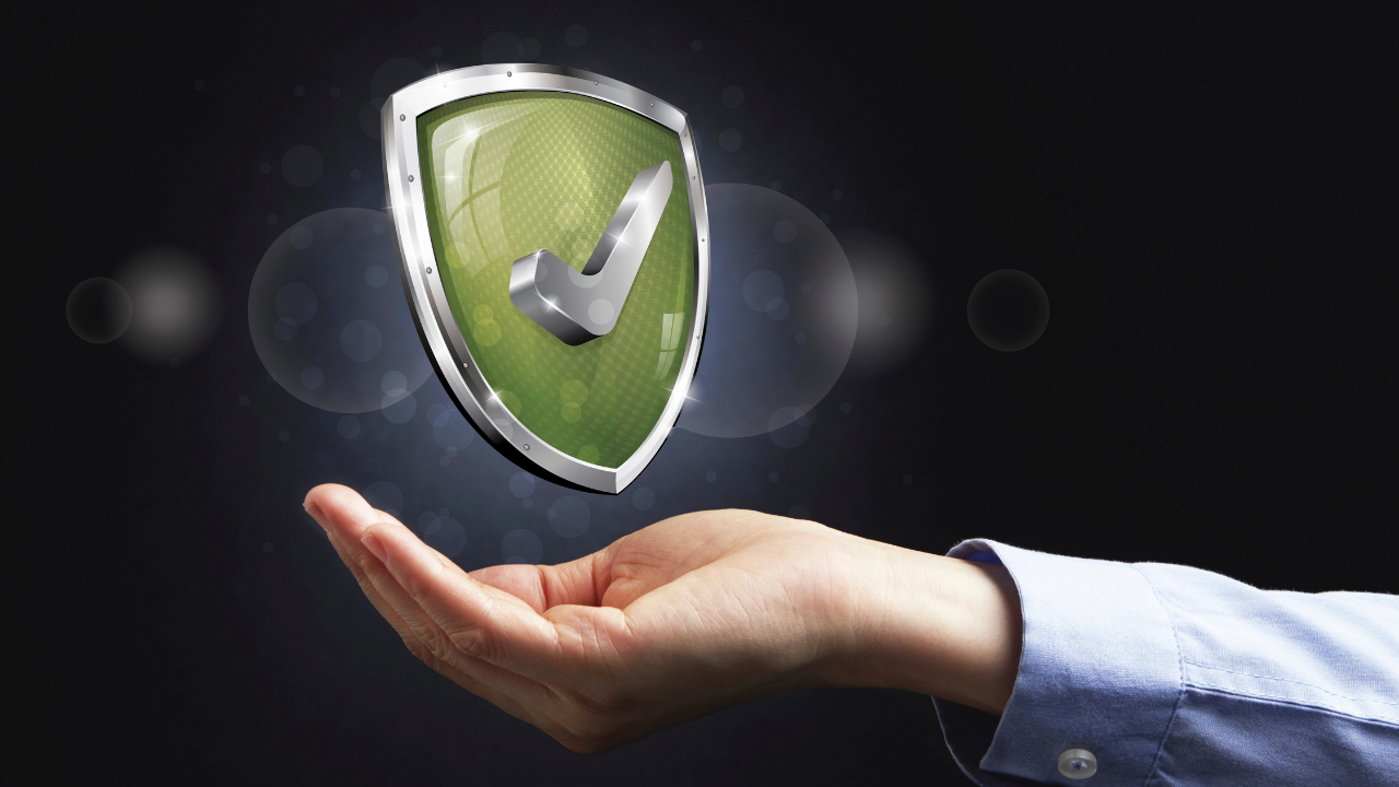 The palm of a hand holding a shield | Scott Legal, P.C. The palm of a hand holding a shield