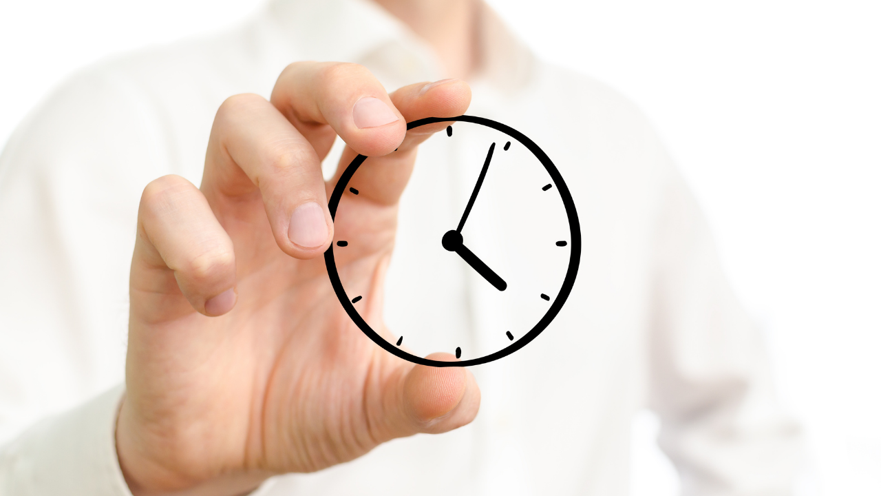 A hand holding a clock | Scott Legal, P.C. A hand holding a clock