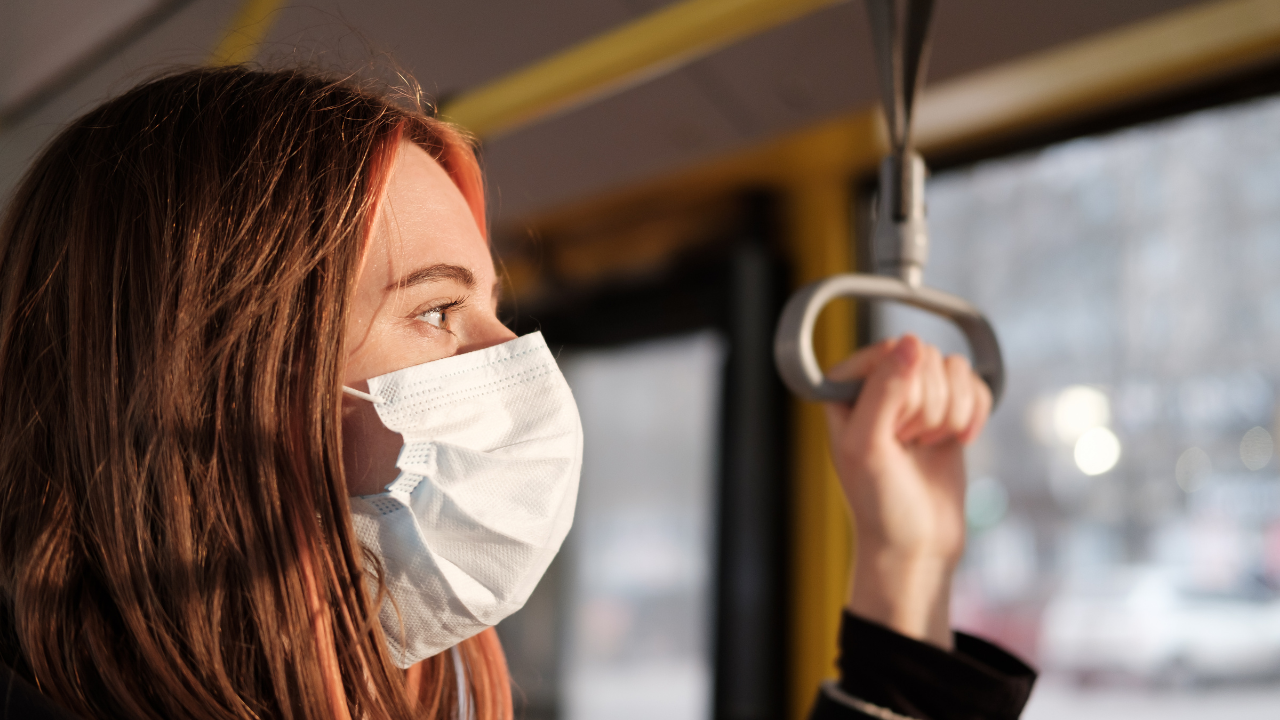 A woman wearing a mask while on public transportation | Scott Legal, P.C. A woman wearing a mask while on public transportation