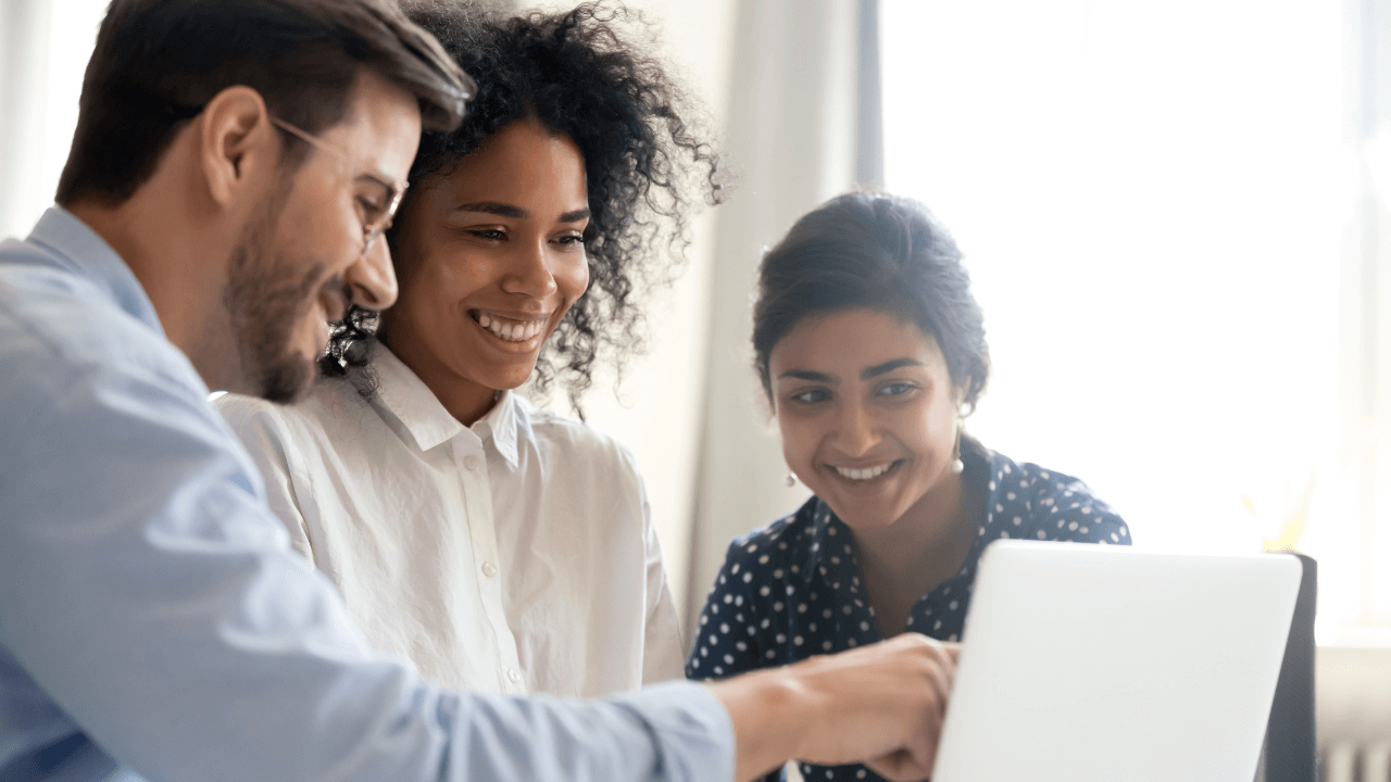A group of 3 people mentoring each other around a presentation on a laptop | Scott Legal, P.C. A group of 3 people mentoring each other around a presentation on a laptop