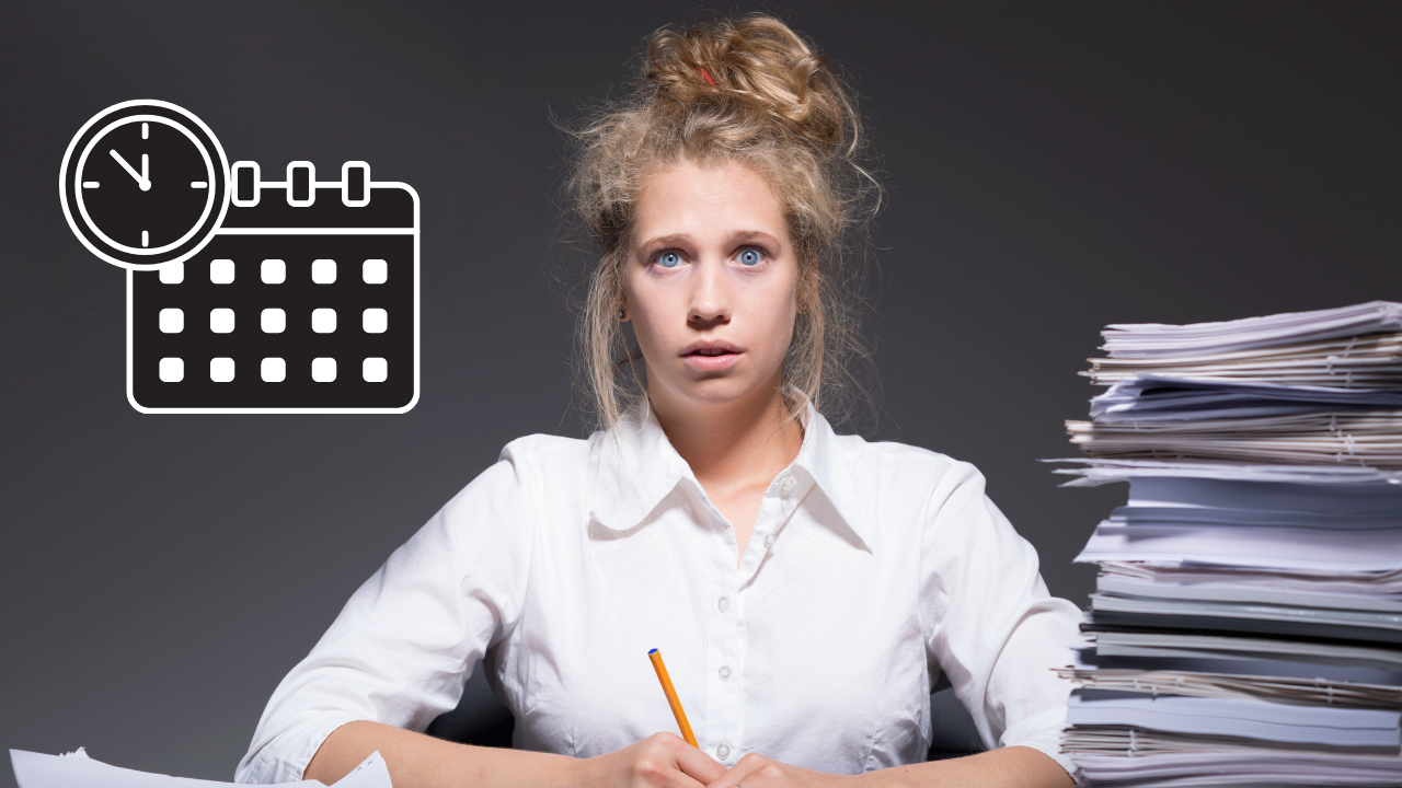 A woman sitting at a desk full of backlog | Scott Legal, P.C. A woman sitting at a desk full of backlog
