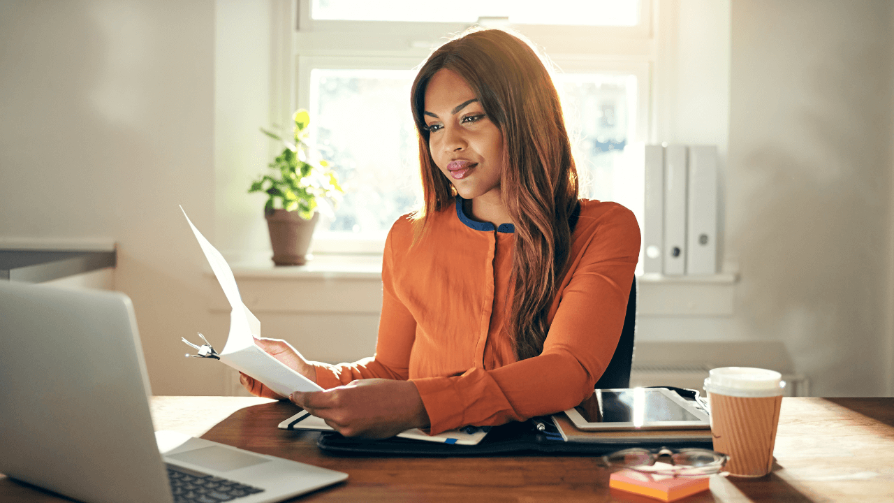 A female entrepreneur working on her laptop in her office | Scott Legal, P.C. A female entrepreneur working on her laptop in her office