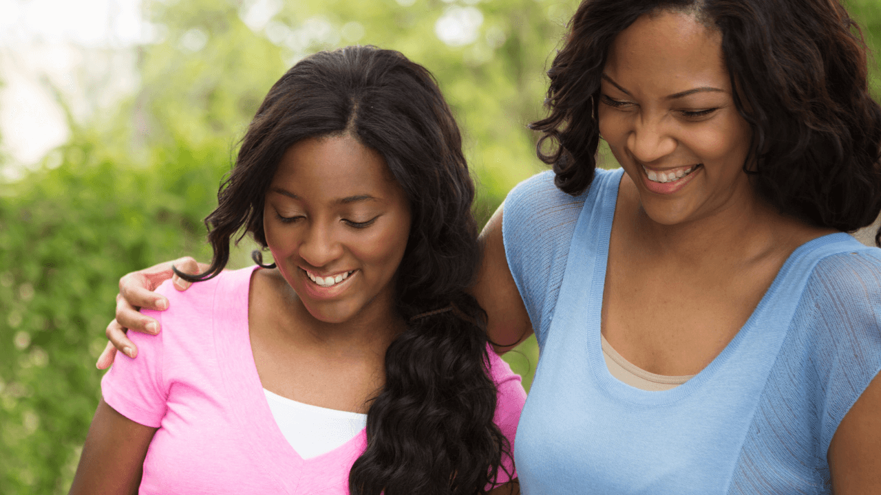 A mother and daughter walking in a park while smiling | Scott Legal, P.C. A mother and daughter walking in a park while smiling