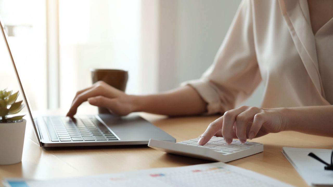 A business woman looking at her business account | Scott Legal, P.C. A business woman looking at her business account