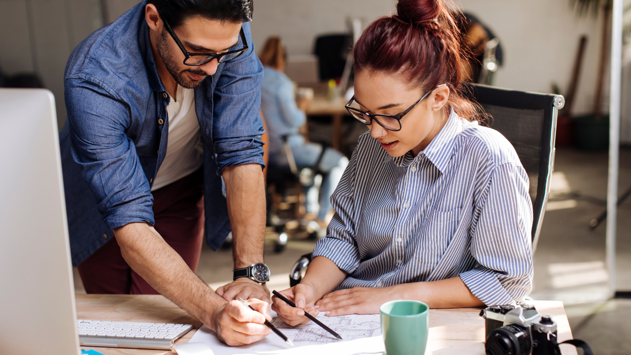 Two entrepreneurs working on an idea together | Scott Legal, P.C. Two entrepreneurs working on an idea together
