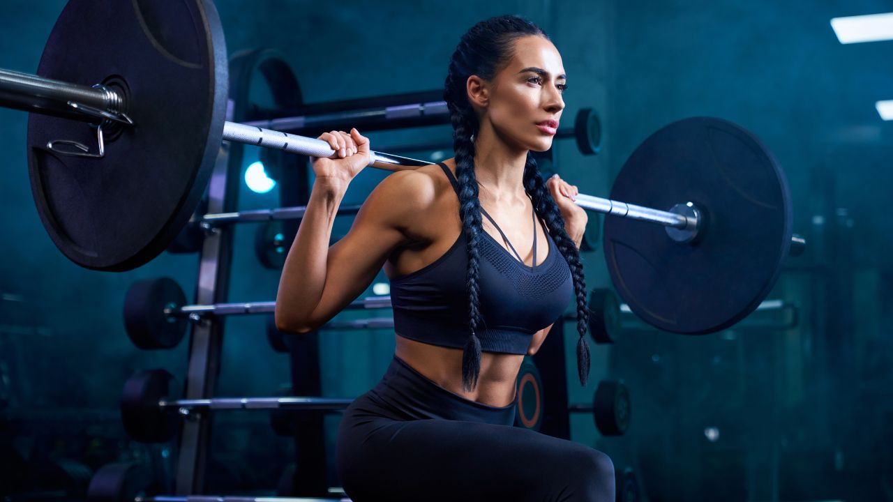 A woman lifting weights | Scott Legal, P.C. A woman lifting weights