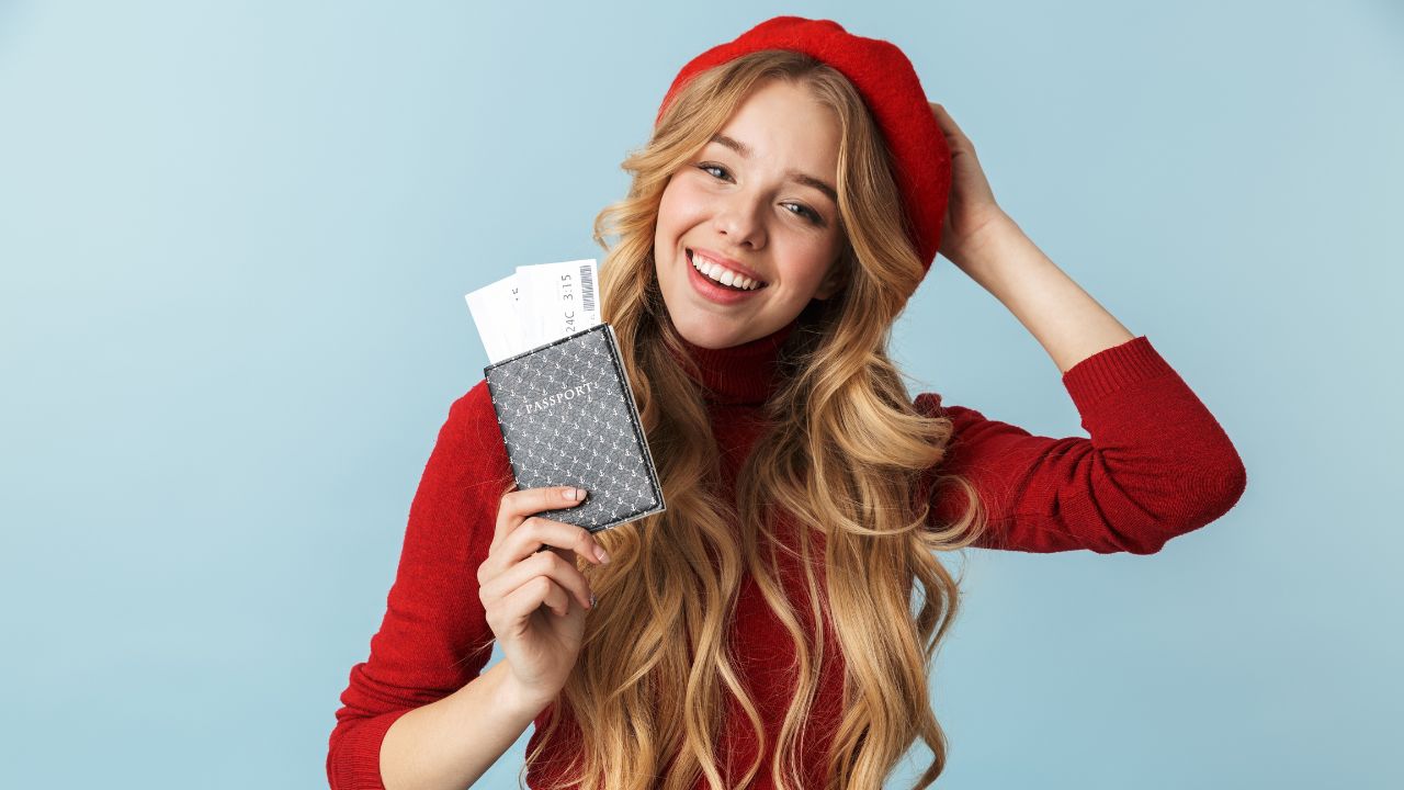 a happy woman holding her passport in preparation to travel | Scott Legal, P.C. a happy woman holding her passport in preparation to travel