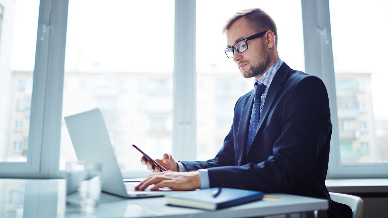 A business man on an L-1 working in his office | Scott Legal, P.C. A business man on an L-1 working in his office