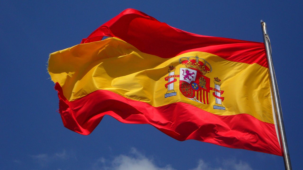 Spain's flag flapping in the wind | Scott Legal, P.C. Spain's flag flapping in the wind