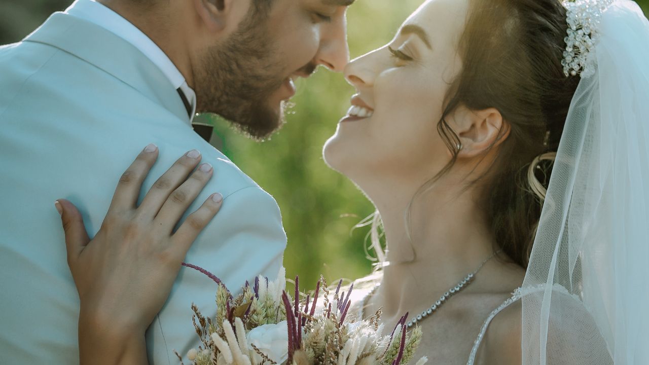 A Married couple smiling at each other in a wedding photo | Scott Legal, P.C. A Married couple smiling at each other in a wedding photo