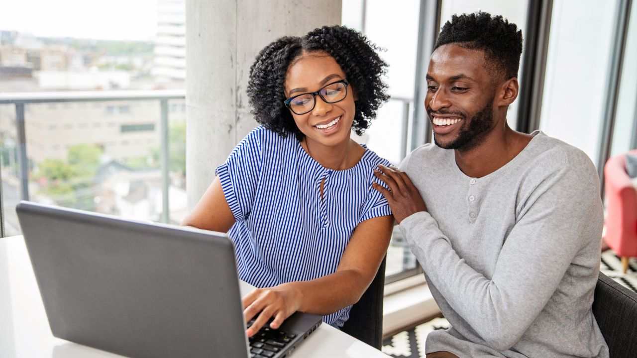 A couple celebrating a green card approval | Scott Legal, P.C. A couple celebrating a green card approval